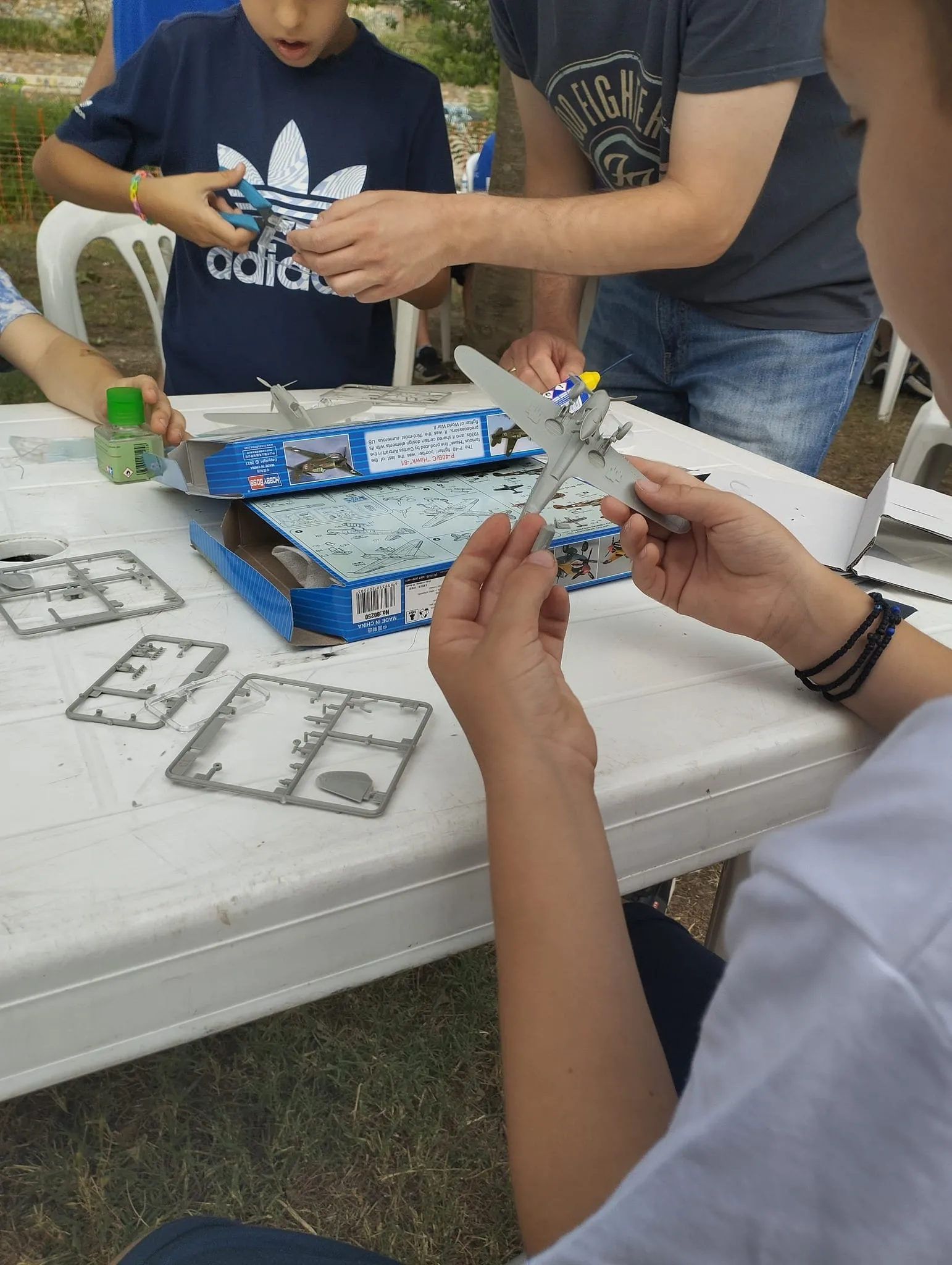 Kids making plastic airplane models